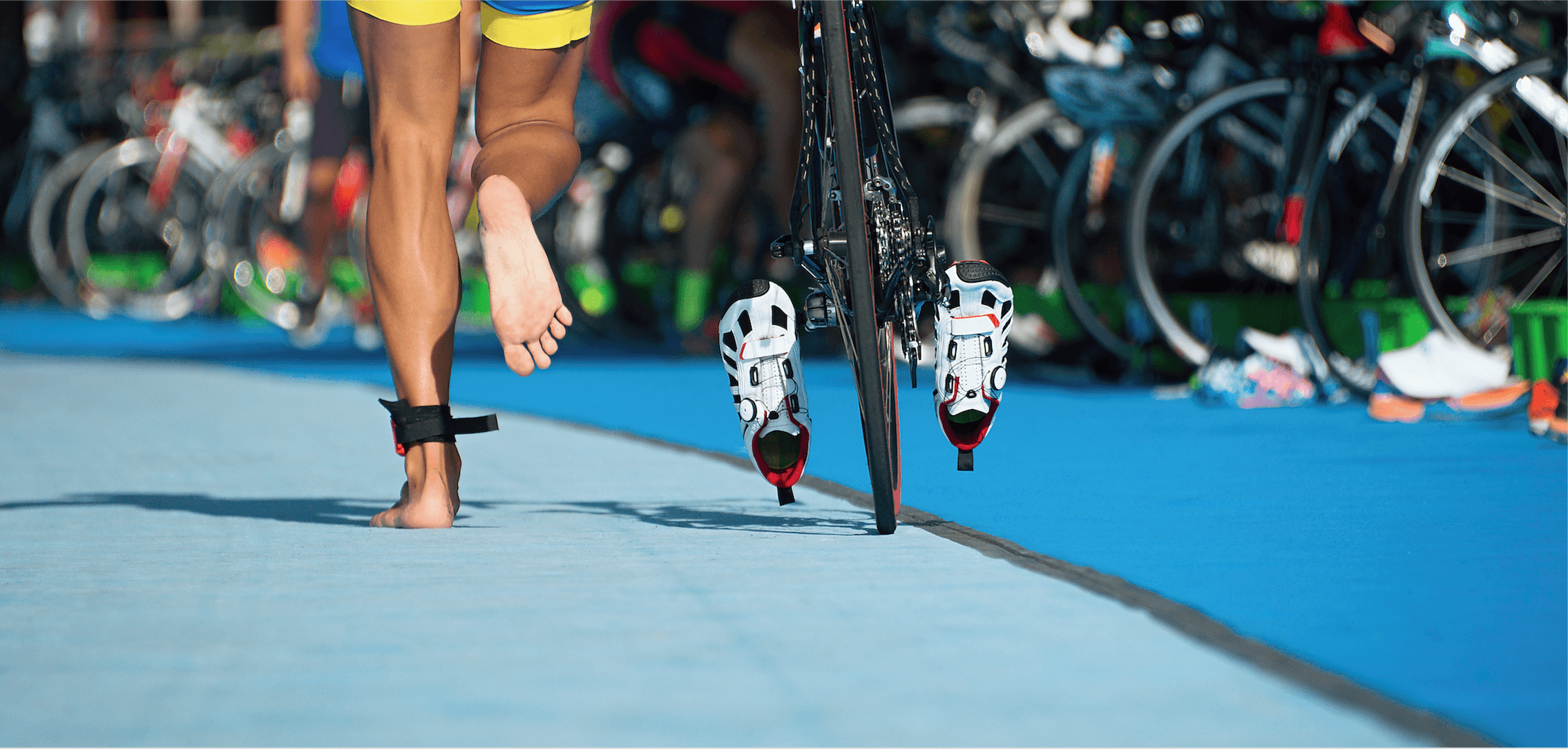 Barefoot running alongside bike with pedals clipped in